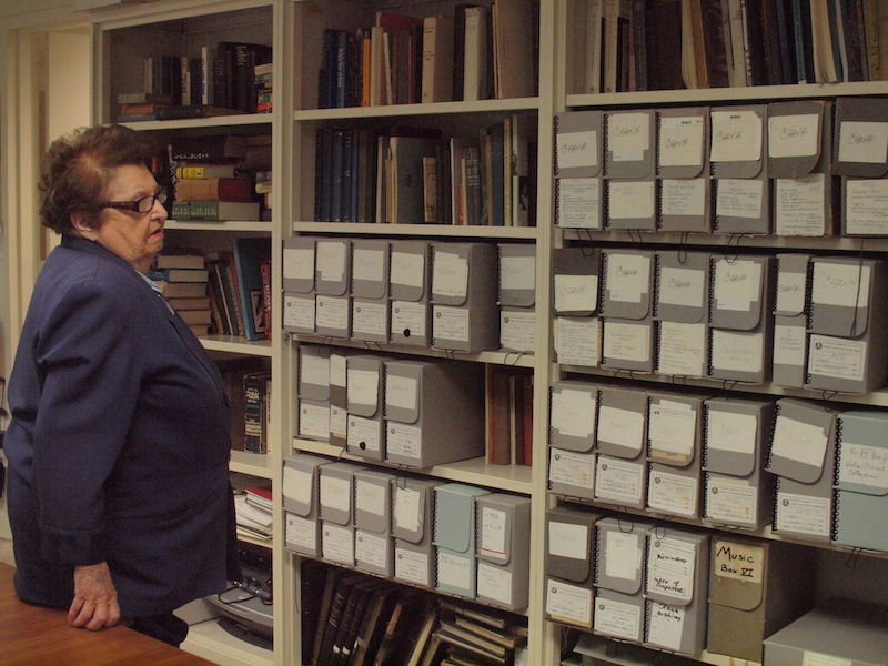 Chana standing with her research collection at YIVO